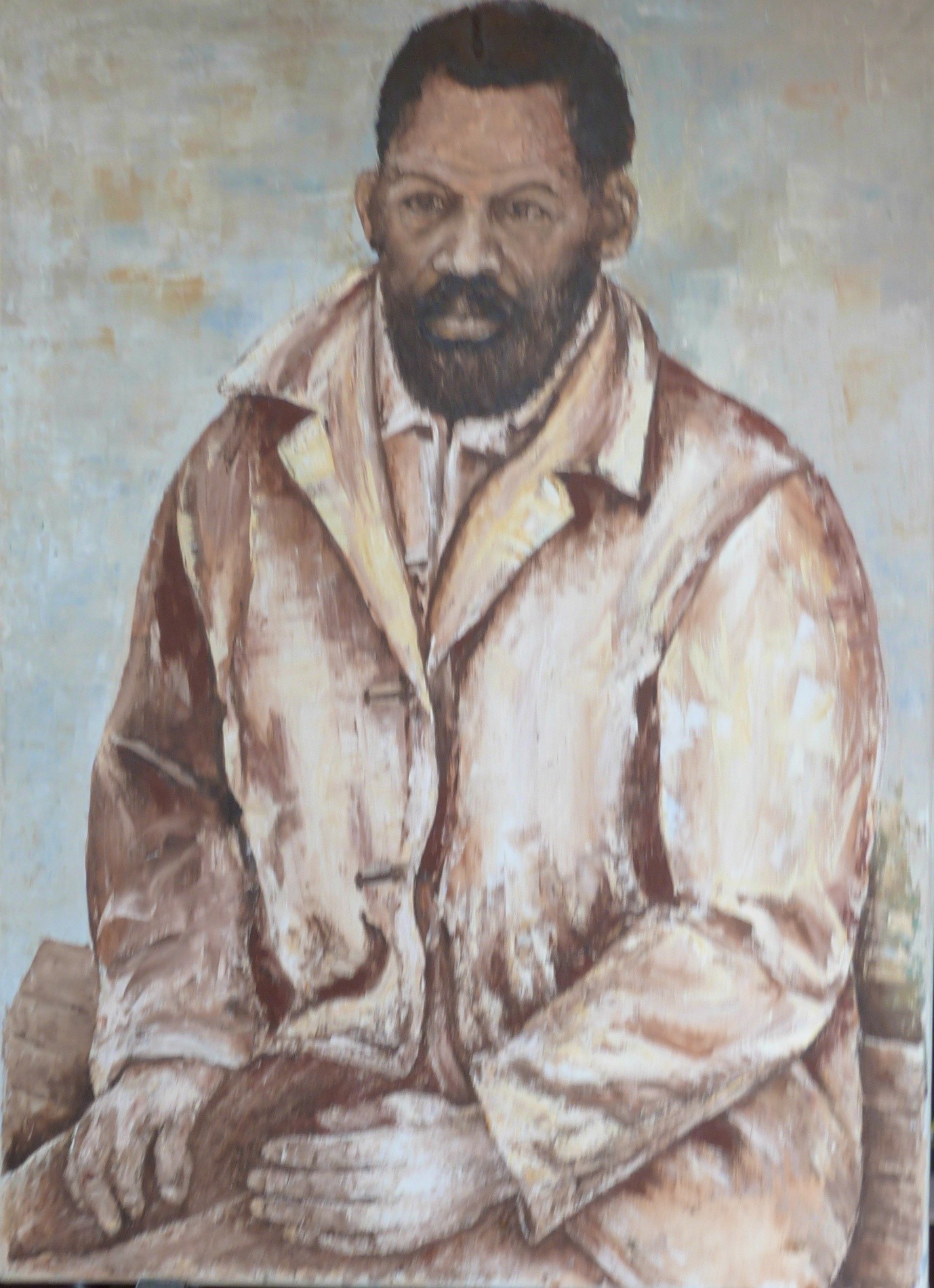 Portrait painting of a young bearded Black man in a pale waxed overcoat, seated with his hands in his lap against a cold blue-grey background.
